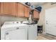 Well-equipped laundry room with updated machines and ample storage cabinets at 4610 S Hassett Cir, Mesa, AZ 85212