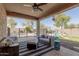 Charming covered patio with comfortable seating area overlooking the pool and backyard at 4610 S Hassett Cir, Mesa, AZ 85212