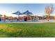 Community playground with slides, climbing structures, and shaded picnic tables for Gathering gatherings at 4610 S Hassett Cir, Mesa, AZ 85212