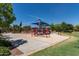 Neighborhood playground area with modern equipment and a soft surface for safety at 4610 S Hassett Cir, Mesa, AZ 85212
