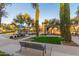 Community playground with slides, climbers, and stone gazebo with bench, perfect for year-round fun at 4610 S Hassett Cir, Mesa, AZ 85212