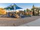 Community playground with slides, climbers, and shaded areas for year-round fun at 4610 S Hassett Cir, Mesa, AZ 85212