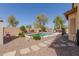 Beautiful pool area complemented by desert landscaping and mature trees at 4610 S Hassett Cir, Mesa, AZ 85212