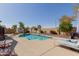 Sparkling pool with manicured landscaping creating a serene backyard oasis at 4610 S Hassett Cir, Mesa, AZ 85212