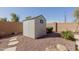 Practical pool shed nestled in the landscape near pool at 4610 S Hassett Cir, Mesa, AZ 85212