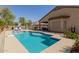 Inviting pool surrounded by lush landscaping and a secure fence at 4610 S Hassett Cir, Mesa, AZ 85212