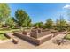 Community sand pit with benches and low brick walls, perfect for to play in the sand at 4610 S Hassett Cir, Mesa, AZ 85212