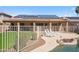 A beautiful backyard view with a covered patio, pool, and solar panels on the roof at 4829 E Charleston Ave, Scottsdale, AZ 85254