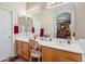 Bathroom featuring double sink vanity, a large mirror, and an arched doorway at 4829 E Charleston Ave, Scottsdale, AZ 85254