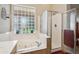 Bathroom view showcasing a garden tub and a glass-enclosed shower at 4829 E Charleston Ave, Scottsdale, AZ 85254