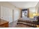Bedroom with carpet, neutral walls, two closets, and a window with blinds and curtains at 4829 E Charleston Ave, Scottsdale, AZ 85254