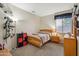 Well-lit bedroom with carpet flooring and a window with blind for natural light at 4829 E Charleston Ave, Scottsdale, AZ 85254