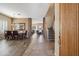 Open dining and living area with wood-look tile floors, stone accents, and a staircase to the upper level at 4829 E Charleston Ave, Scottsdale, AZ 85254
