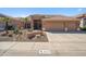Charming single-story home with a well-maintained desert-landscaped front yard and a spacious three car garage at 4829 E Charleston Ave, Scottsdale, AZ 85254