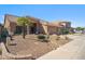 Beautiful single-story home with a low maintenance front yard featuring desert landscaping, gravel and palm trees at 4829 E Charleston Ave, Scottsdale, AZ 85254