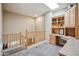 Upstairs hallway with light gray carpet, railing and a built-in desk area and shelves at 4829 E Charleston Ave, Scottsdale, AZ 85254