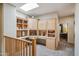 Hallway features built-in bookshelves and cabinets illuminated by a skylight at 4829 E Charleston Ave, Scottsdale, AZ 85254