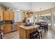 Bright kitchen with stainless steel appliances, granite countertops, central island, and breakfast nook at 4829 E Charleston Ave, Scottsdale, AZ 85254