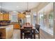 Sunlit eat-in kitchen with wooden cabinets, stainless appliances, and dining table near bright windows at 4829 E Charleston Ave, Scottsdale, AZ 85254
