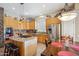 Spacious kitchen featuring wooden cabinets, an island cooktop, stainless appliances, and a dining area at 4829 E Charleston Ave, Scottsdale, AZ 85254