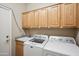 Bright laundry room featuring modern washer and dryer, sink, and ample cabinet storage at 4829 E Charleston Ave, Scottsdale, AZ 85254