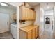 Convenient laundry room includes cabinetry for storage, counter space, and tile flooring at 4829 E Charleston Ave, Scottsdale, AZ 85254