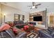 Inviting living room features a stone accent wall, entertainment center, and comfortable leather sectional at 4829 E Charleston Ave, Scottsdale, AZ 85254