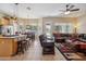 Open-concept space featuring kitchen, dining area, and comfortable living room with a ceiling fan and patio access at 4829 E Charleston Ave, Scottsdale, AZ 85254