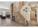 Hallway and staircase with stone wine fridge, opening into the living room at 4829 E Charleston Ave, Scottsdale, AZ 85254