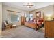 A spacious primary bedroom with a ceiling fan, natural light, and carpet flooring at 4829 E Charleston Ave, Scottsdale, AZ 85254