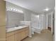 Bright bathroom with a single sink vanity, framed mirror, bathtub and shower combination, and tiled flooring at 5303 N 7Th St # 134, Phoenix, AZ 85014