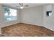 Empty bedroom featuring hardwood floors, and a large window with blinds at 5303 N 7Th St # 134, Phoenix, AZ 85014