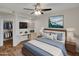 Cozy bedroom with a mounted TV, ceiling fan, and closet with an open doorway at 5303 N 7Th St # 134, Phoenix, AZ 85014