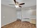 An airy bedroom featuring wood floors, a ceiling fan, and a built-in desk area at 5303 N 7Th St # 134, Phoenix, AZ 85014