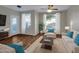 Bright living room featuring wood floors, a ceiling fan, and comfortable seating arrangements at 5303 N 7Th St # 134, Phoenix, AZ 85014