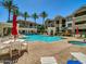 Resort-style pool with lounge chairs, tables, and lush palm trees offering a perfect outdoor oasis at 5303 N 7Th St # 134, Phoenix, AZ 85014
