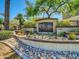 Landscaped sign for The Carlyle Condominium with address and rock garden adding curb appeal at 5303 N 7Th St # 134, Phoenix, AZ 85014