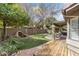Backyard with putting green, lush greenery, and covered patio area at 5755 W Harrison St, Chandler, AZ 85226