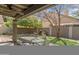 Charming backyard oasis with a rock water feature, lush greenery, and covered patio at 5755 W Harrison St, Chandler, AZ 85226