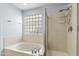 Bright bathroom with a glass block window, a soaking tub and separate shower at 5755 W Harrison St, Chandler, AZ 85226