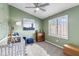 Bedroom features olive green walls, neutral carpet and ceiling fan at 5755 W Harrison St, Chandler, AZ 85226
