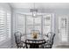 Bright dining area with white shutters, modern light fixture and rustic round table at 5755 W Harrison St, Chandler, AZ 85226