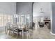 Open-concept dining room with large windows and views of a fireplace and sitting area at 5755 W Harrison St, Chandler, AZ 85226