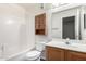 Cozy bathroom features a shower-tub combo, wood vanity, and mirrored medicine cabinet at 5808 E Brown Rd # 42, Mesa, AZ 85205