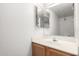 Bathroom with single sink vanity, mirror, white walls and a hardwood cabinet at 5808 E Brown Rd # 42, Mesa, AZ 85205