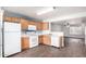 Bright kitchen features white appliances, oak cabinets, and flows into the living area at 5808 E Brown Rd # 42, Mesa, AZ 85205