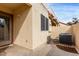 Private outdoor patio with air conditioning unit and stucco walls provides a relaxing space at 5808 E Brown Rd # 42, Mesa, AZ 85205