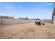 Large backyard featuring a neutral color palette, surrounded by block fence and a cozy fire pit area at 6225 W Mary Jane Ln, Glendale, AZ 85306