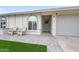 Inviting front entrance with a stone pathway, chairs, and gray garage door at 6225 W Mary Jane Ln, Glendale, AZ 85306