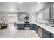 Well-lit kitchen with stainless steel appliances, quartz countertops, and open layout at 6225 W Mary Jane Ln, Glendale, AZ 85306